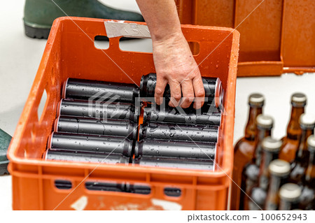 dewy cans of beer in a brewery in a dispatch warehouse 100652943
