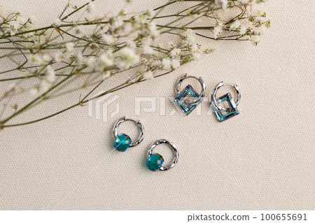 Elegant jewelry set of silver earrings with gem. Jewelry set minimalist style. Handmade bijouterie concept. Elegant jewelry set of silver earrings with gem. Jewelry set minimalist style. Handmade bijouterie concept. 100655691