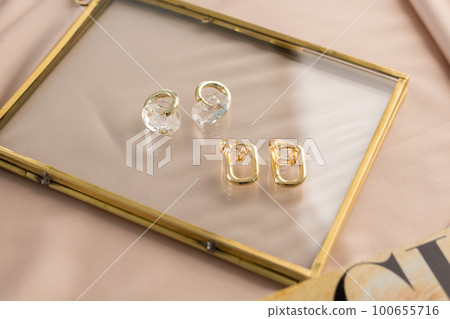 Elegant jewelry set of gold earrings. Jewelry set minimalist style. Handmade bijouterie concept. Elegant jewelry set of gold earrings. Jewelry set minimalist style. Handmade bijouterie concept. 100655716