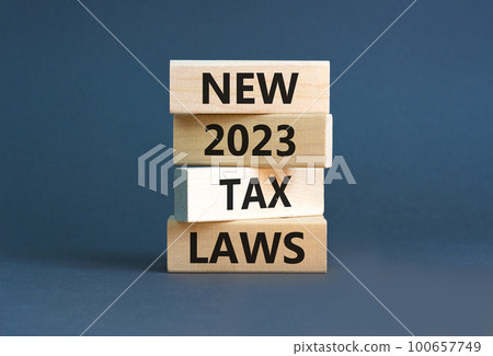New 2023 tax laws symbol. Concept words New 2023 tax laws on wooden blocks. Beautiful grey table grey background. Business new 2023 tax laws concept. Copy space. 100657749