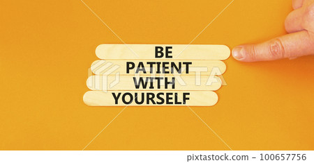 Patient with yourself symbol. Concept words Be patient with yourself on wooden stick. Beautiful orange table orange background. Businessman hand. Business patient with yourself concept. Copy space. Patient with yourself symbol. Concept words Be patient with yourself on wooden stick. Beautiful orange table orange background. Businessman hand. Business patient with yourself concept. Copy space. 100657756