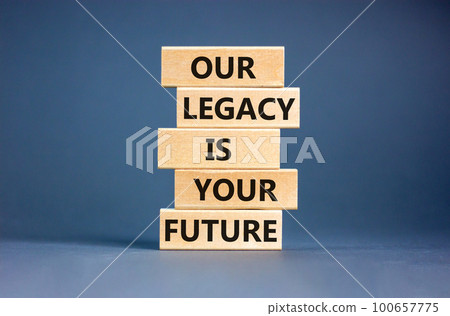 Legacy and future symbol. Concept words Our legacy is your future on wooden blocks. Beautiful grey table grey background. Business legacy and future concept. Copy space. 100657775