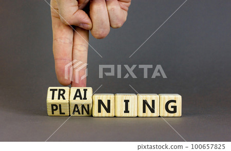Training and planning symbol. Concept word Training and Planning on wooden cubes. Businessman hand. Beautiful grey table grey background. Business training and planning concept. Copy space. 100657825