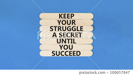 Keep secret symbol. Concept words Keep your struggle a secret until you succeed on wooden stick. Beautiful blue table blue background. Copy space. Motivational business keep secret concept. 100657847
