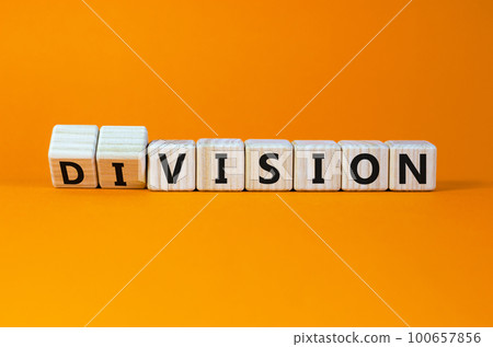 Division or vision symbol. Turned cubes and changed the word 'division' to 'vision'. Beautiful orange table, orange background. Business, division or vision concept. Copy space. 100657856