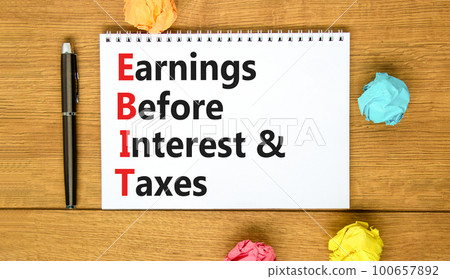 EBIT symbol. Concept words EBIT earnings before interest and taxes on white note on beautiful wooden background. Business EBIT earnings before interest and taxes concept. Copy space. EBIT symbol. Concept words EBIT earnings before interest and taxes on white note on beautiful wooden background. Business EBIT earnings before interest and taxes concept. Copy space. 100657892