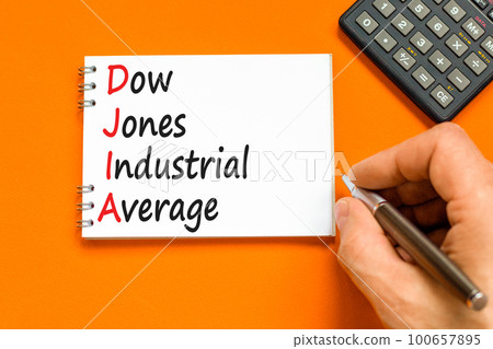 DJIA Dow Jones industrial average symbol. Concept words DJIA Dow Jones industrial average on white note on beautiful orange background. Business DJIA Dow Jones industrial average concept. Copy space 100657895