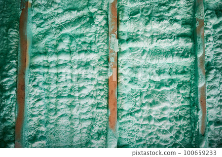 Cropped view of wall in wooden frame house thermal insulated by polyurethane foam. Construction and insulation concept. Cropped view of wall in wooden frame house thermal insulated by polyurethane foam. Construction and insulation concept. 100659233