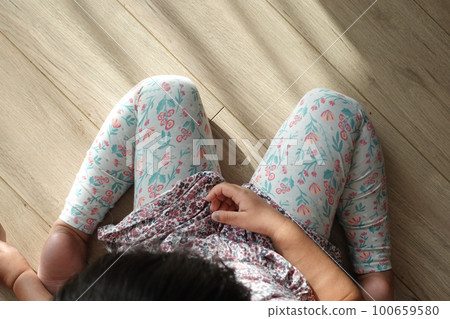 child sitting W posture on the floor . 100659580