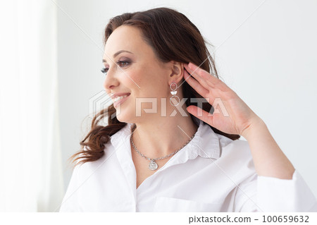 Fashionable and stylish woman in trendy jewelry big earrings . Fashion look beauty and style. Natural makeup and easy styling Fashionable and stylish woman in trendy jewelry big earrings . Fashion look beauty and style. Natural makeup and easy styling 100659632