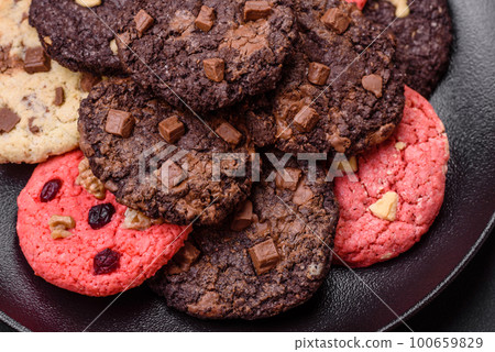 Delicious fresh crispy oatmeal cookies with chocolate and nuts Delicious fresh crispy oatmeal cookies with chocolate and nuts 100659829