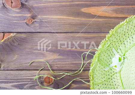 Beach hat on a wooden background. Place for the inscription. Vacation concept Beach hat on a wooden background. Place for the inscription. Vacation concept 100660099