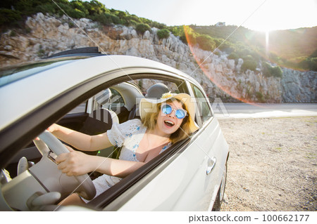 Young woman drive and having fun in cabrio against mountains copy space and empty place for text - travel and summer voyage nature concept Young woman drive and having fun in cabrio against mountains copy space and empty place for text - travel and summer voyage nature concept 100662177