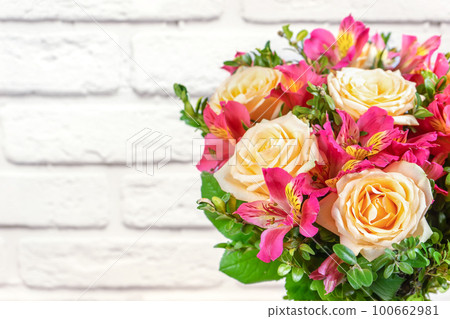 Bouquet of beautiful roses and alstroemeria on white background with copy space. Floral shop concept 100662981