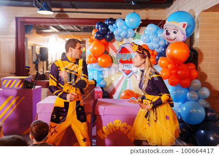 man and woman actors play at a children's party. man and woman actors play at a children's party. 100664417