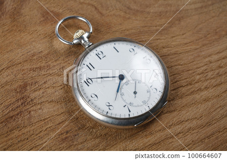 Pocket watch on wooden background Pocket watch on wooden background 100664607