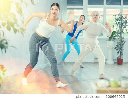 Young woman is dancing in fitness studio 100666025