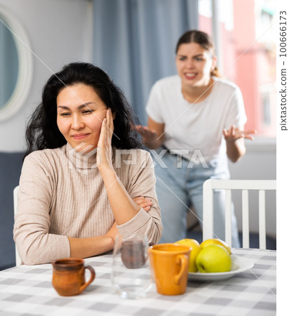 Outraged girl yells at her friend during domestic quarrel Outraged girl yells at her friend during domestic quarrel 100666173