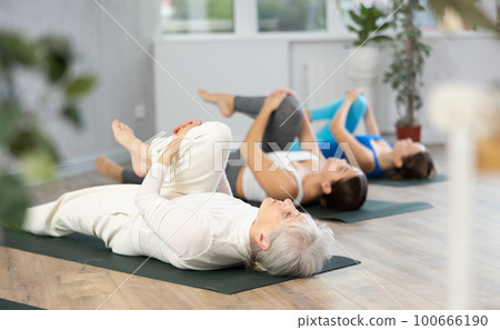 Elderly woman doing yoga in fitness studio Elderly woman doing yoga in fitness studio 100666190