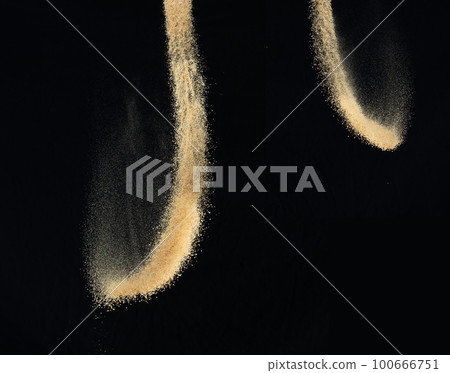 Sand flying explosion, Golden sand wave explode. Abstract sands cloud fly. Yellow colored sand splash throwing in Air. black background Isolated high speed shutter, throwing freeze stop motion Sand flying explosion, Golden sand wave explode. Abstract sands cloud fly. Yellow colored sand splash throwing in Air. black background Isolated high speed shutter, throwing freeze stop motion 100666751