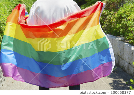 Back view of a man with a rainbow-colored cloak, no face Back view of a man with a rainbow-colored cloak, no face 100668377