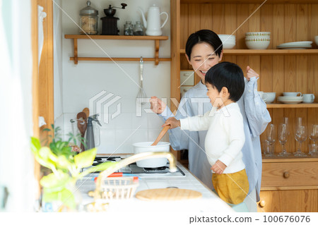 A 3-year-old boy playing with his mother in the kitchen 100676076