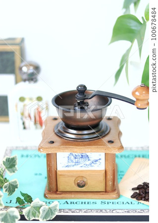 Hand-operated stylish coffee mill with white background Hand-operated stylish coffee mill with white background 100678484