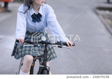 School girls riding a bicycle School girls riding a bicycle 100679146