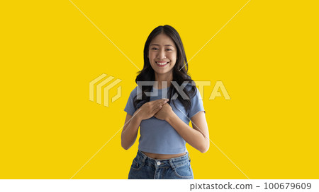 Woman smiling happily isolated on yellow background, Woman loves and rejoices herself, Contented, Pure love, Love myself, Proud of yourself, Self-made happiness, Painting Therapy with a smile. 100679609