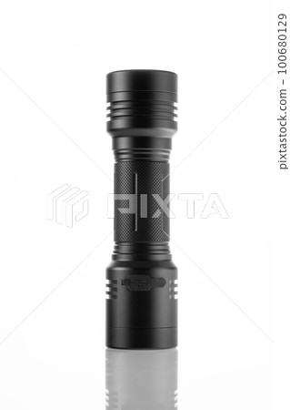 LED black flashlight close-up on white background, trace of bright light LED black flashlight close-up on white background, trace of bright light 100680129