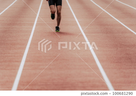 Male runner running straight on athletics track Male runner running straight on athletics track 100681290