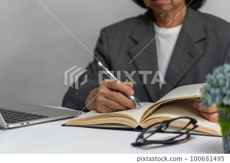 Woman hands with pen writing on notebook in the office.learning, education and work.writes goals, plans, make to do and wish list on desk. Woman hands with pen writing on notebook in the office.learning, education and work.writes goals, plans, make to do and wish list on desk. 100681495