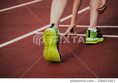 Runners at the starting line on an athletics track Runners at the starting line on an athletics track 100681661