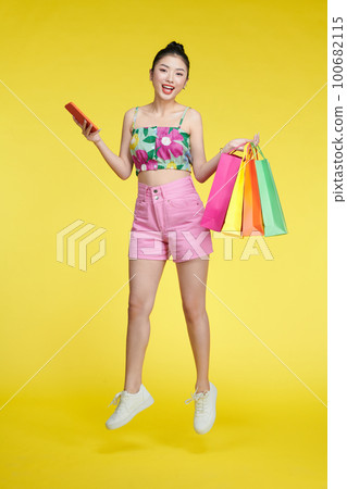 Full length photo of pretty positive lady hold store mall packages use telephone 100682115
