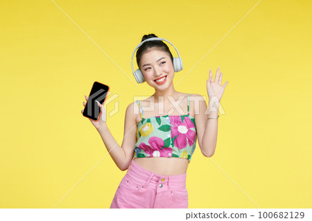 Girl enjoying wireless earphones and dancing Girl enjoying wireless earphones and dancing 100682129
