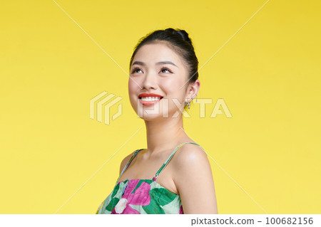 Beautiful healthy woman smiling on yellow background portrait Beautiful healthy woman smiling on yellow background portrait 100682156