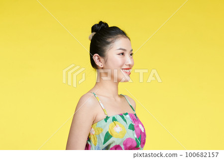 Beautiful healthy woman smiling on yellow background portrait 100682157