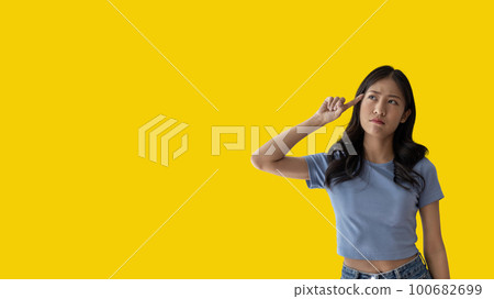 Young Asian woman thinking hard or planning to do something, Overthinking or worrying, Have a headache, Migraine, Stress, Free space for advertising or promoting products, Copy space, Enter text. 100682699