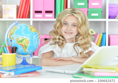 girl using laptop at desk at home 100682872