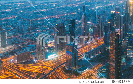 Aerial View Of Night Scenic View Of Dubai Skyline. Evening Night Scenic View Of Skyscraper. Street Night Illumination Of High-rise Buildings Of Residential District In Dubai. High quality photo 100683229
