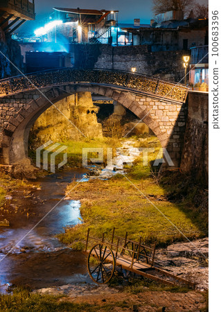 Tbilisi, Georgia, Night Scenic View Of Bridge of Love in Bath District - Is The Ancient District Of Tbilisi, Georgia. Sulfuric Baths, rvier in canyon Tbilisi, Georgia, Night Scenic View Of Bridge of Love in Bath District - Is The Ancient District Of Tbilisi, Georgia. Sulfuric Baths, rvier in canyon 100683396