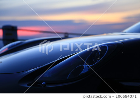 black sports car at dawn black sports car at dawn 100684071