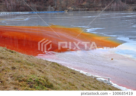 Pollution of a lake with contaminated water from a gold mine. Pollution of a lake with contaminated water from a gold mine. 100685419