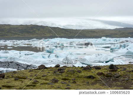 Floating icebergs melting in Fjallsarlon glacier lake, Iceland Floating icebergs melting in Fjallsarlon glacier lake, Iceland 100685620
