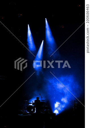 Silhouette of drummer performing live Silhouette of drummer performing live 100686463