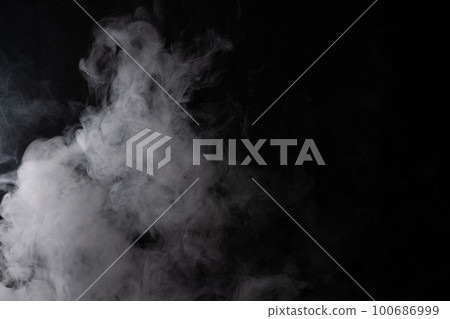 Cloud of white smoke on a black background closeup Cloud of white smoke on a black background closeup 100686999
