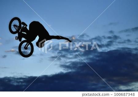 BMX rider making a bike jump 100687348