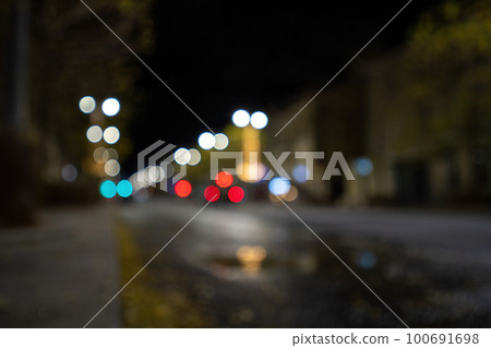 Blurred footage of transport. Blur of city lights along the road, light out of focus at night. Night city traffic, beautiful background. Blurred footage of transport. Blur of city lights along the road, light out of focus at night. Night city traffic, beautiful background. 100691698