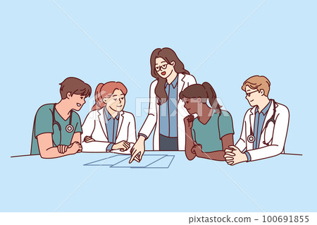 Clinic staff meeting, with doctors sitting at table and head physician giving instructions 100691855