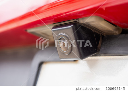 Red car rear view camera close up for parking assistance Red car rear view camera close up for parking assistance 100692145